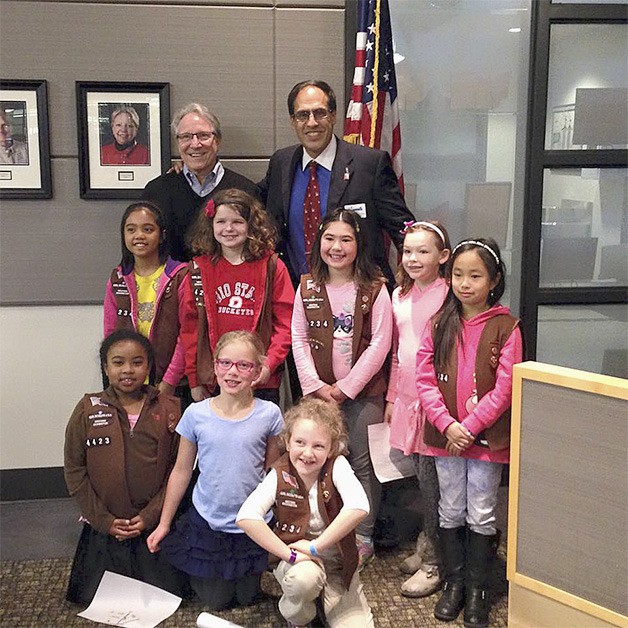 Council members Bob Keller and Ramiro Valderrama-Aramayo pose with several Brownies at the Girl Scouts of Western Washington local government night in Sammamish March 23.
