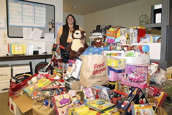 Detective Amy Jarboe with the police department’s Toys for Tots donations from 2014.