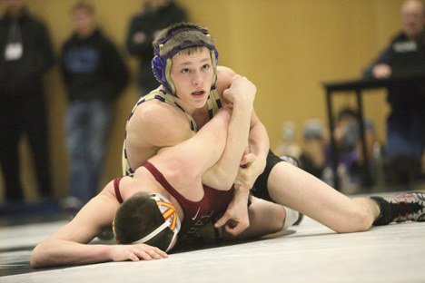 Issaquah senior David White works his way to a 7-2 decision over Bethel's Austin Henderson on Saturday. White won the 145-pound title and enters the Mat Classic as a No. 1 seed.