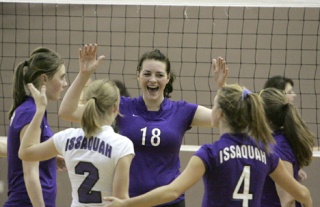 Issaquah High School's Chrissy Dickinson (No. 18) celebrates with her team during a volleyball game at Redmond High School on Tuesday