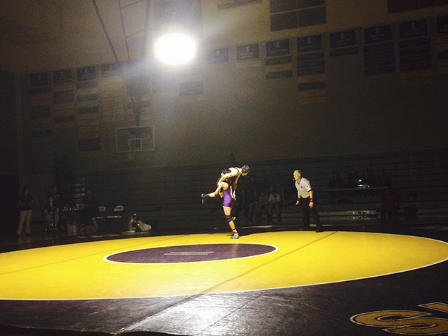 Issaquah 126-pound wrestler Stevie Solusod lifts Inglemoor’s Bailey Claudon into the air before taking him down on Jan. 7 at Issaquah High School. Solusod defeated Claudon 21-6 in the match.