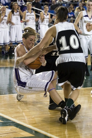 Issaquah's Alexa Smith battles for the ball with Jackson's Chanel Sam (10) and Erin Feeney (11) on Wednesday night at the Tacoma Dome.