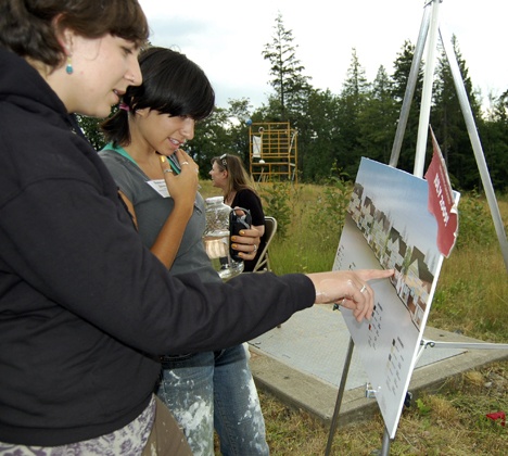 AmeriCorps volunteers Liz Nixon and Susannah Zeveloff take a look at plans for the five unit site to be built in the Issaquah Highlands by Habitat for Humanity.