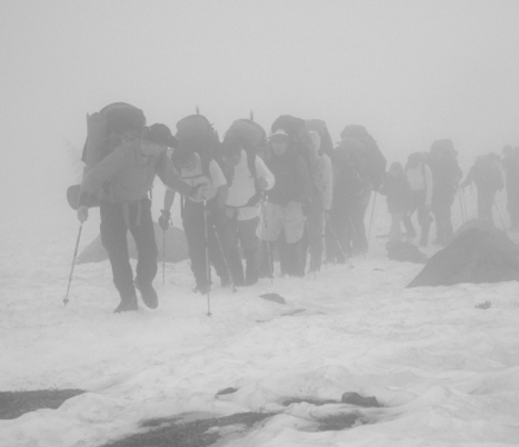 Issaquah High School graduate and former Navy SEAL Ryan Job walks into the clouds with a team of wounded veterans on an ascent of Mt Rainier. The group began the climb on Tuesday and were back at the bottom by Friday afternoon.
