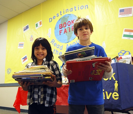 Endeavour Elementary School second-graders Hilary Martin and Ethan Berg are very proud that their school has raised more than 100 books for families through the Issaquah Food and Clothing Bank.