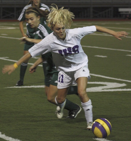Issaquah's Dayna Talley fends off the Woodinville defense Tuesday as the Eagles defeated the Falcons 3-1.