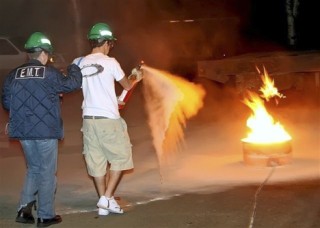 Joan Murphy and her son Chris perform a fire response during CERT training in Sammamish.