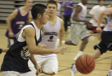 Guard Derek Quan pushes the ball up court in practice earlier this week. The junior is one of five new Issaquah starters.