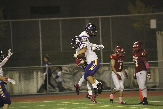 Issaquah players Joe Nelson and Kirin Junsay celebrate after Junsay rumbled for an 80-yard touchdown