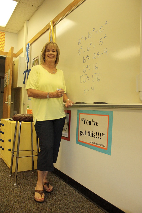 Anne Steindorf works math problems on the whiteboard in her classroom at Inglewood Middle School. Steindorf