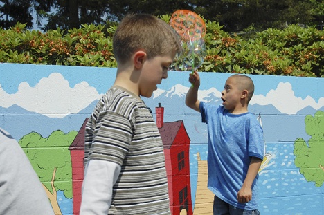Challenger Elementary students Michael Popa and Dominic Diaz enjoy the colorful surrounds of their new play area.