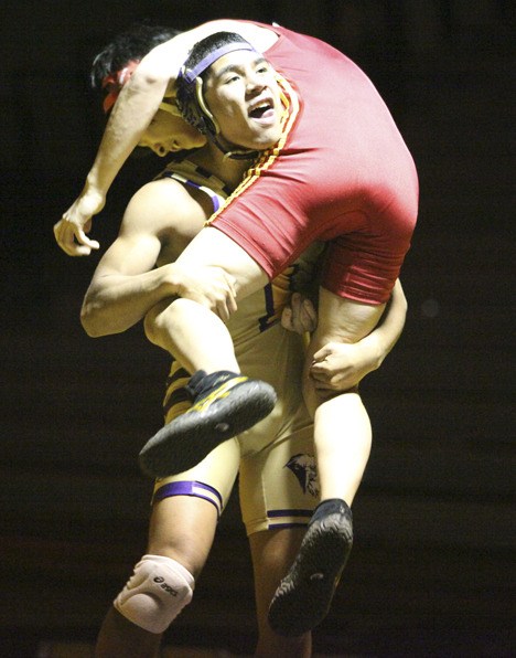 Issaquah junior Almen Thorpe picks up Newport's Steve Heo in the first round of Tuesday's match. Thorpe pinned Yeo 29 seconds into the match.