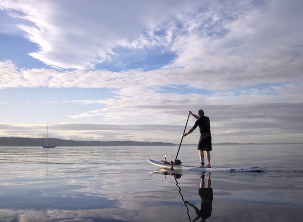 A paddle boarder navigates Puget Sound waters.