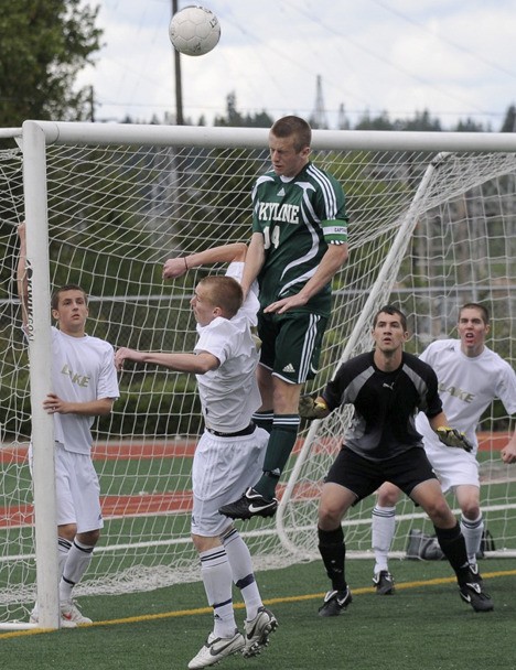 Skyline's Travis Strawn gets airborne for a header Saturday afternoon in a crowd of Lake Stevens' defenders.