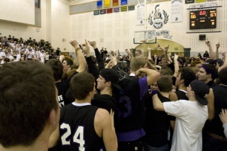 Issaquah fans rush the floor after their team beat Skyline 67-66 in overtime Friday.