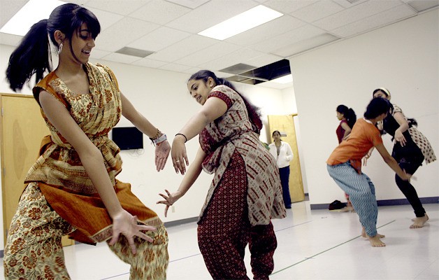 Students perform a dance in preparation for an upcoming performance.