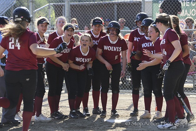 Eastlake players mob Sophia Robinson after she connected on a two-run home run over the left field fence in the bottom of the third inning. Eastlake defeated Issaquah 3-1 on April 18 in Sammamish.
