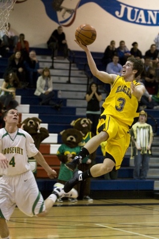 Ross Zuhl skies into the lane for a layup while Roosevelt's Louis Vorhees looks on.