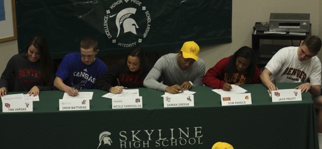 Running back Damian Greene (center in yellow cap) was one of six student-athletes from Skyline's 2012 class to sign a letter of intent