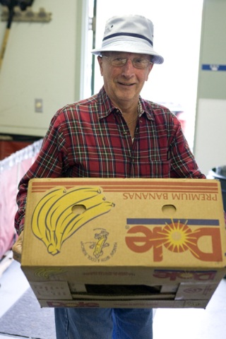 Bob Wolf of Sammamish helps out at the Issaquah Food Bank. Wolf says with a grin that he volunteers his time to 'keep out of trouble.'