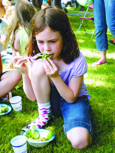 Maeve Patterson enjoys a salad during the Issaquah Valley Elementary first grade salad celebration. The students raised their own vegetables used in the salad as part of a spring long school project.