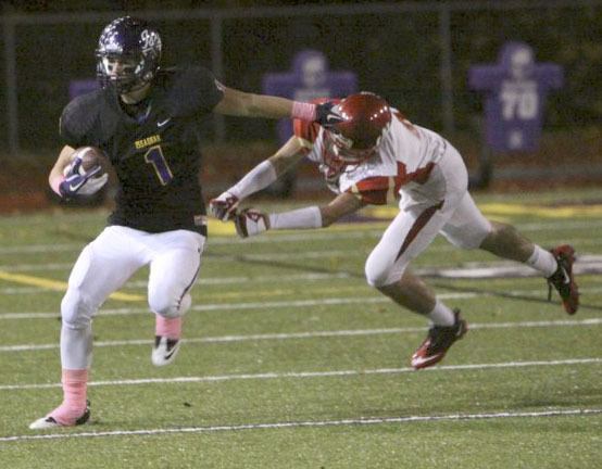 Issaquah's Chas Peterson gives a Newport player a stiff arm Friday night. The Eagles beat the Knights 41-28.