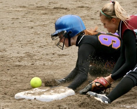 Issaquah's Brielle Bray dives back to first base in the bottom of the fourth inning while Eastlake's Stephanie Clay attempts to field the ball. Bray was hit by the pick-off attempt of catcher Kelsey Dempsey