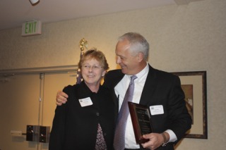 Issaquah Chamber of Commerce Chairman of the Board Bob Ittes hugs Mayor Ava Frisinger