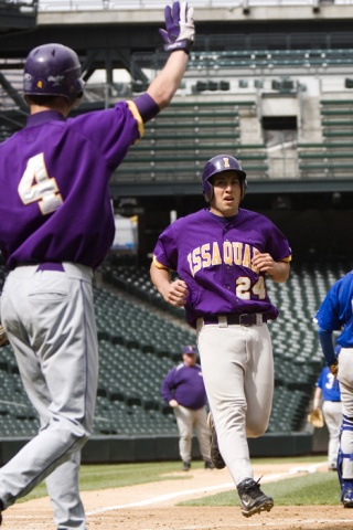 Issaquah's Dustin Talley crosses the plate at Safeco Field Saturday afternoon as teammate Miles Perkins prepares to give a high-five.
