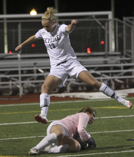 Skyline's Shea O'Donnell leaps over Woodinville goalkeeper Emma Engen Tuesday night.