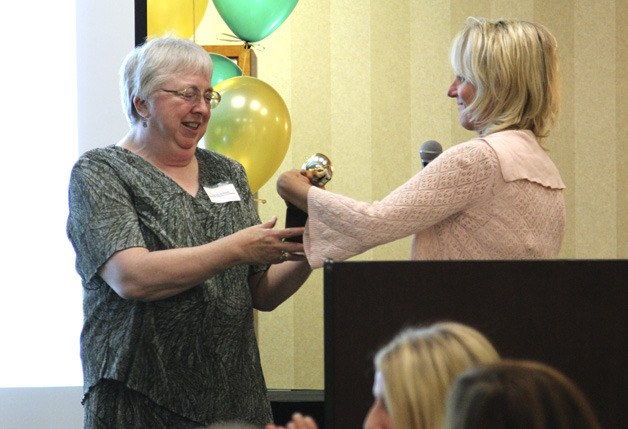 Barbara de Michele receives the Golden Apple award from the Issaquah Schools Foundation during the city’s community awards. She also won the city’s Hall of Fame award.
