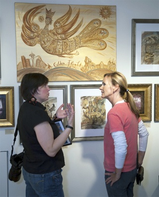 Katya Palladina (left) talks with Janelle Davidson in front of Palladina's 'Golden Flight' painting Aug. 1 at Upfront Gallery in Issaquah. Palladina will display some of her mixed-media paintings Oct. 11 and 12 at the Sammamish Art Fair. The art fair runs 10 a.m. to 5 p.m.  both days at the Sammamish City Hall