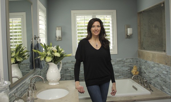 Interior designer Kassi Clark stands in a Sammamish bathroom that she recently remodeled. Clark is one of two local designers recognized at the recent Northwest Design Awards for her exceptional work.