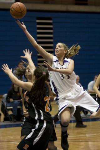 Alexa Smith goes in for two of her 15 points Monday against Monroe.