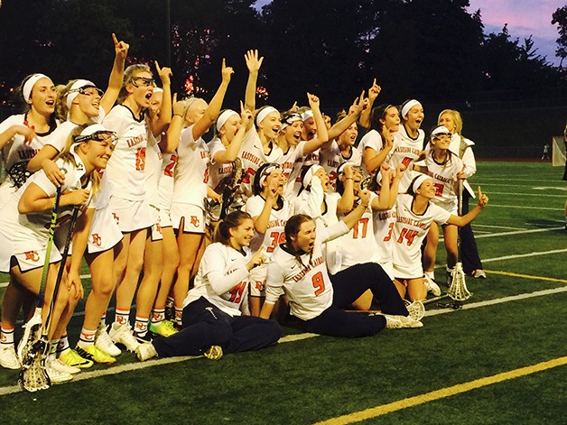 The Eastside Catholic Crusaders girls lacrosse team celebrates after defeating Lake Sammamish 14-4 in the Washington Division 1 girls lacrosse state championship game on May 20 at Bellevue Memorial Stadium.