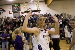 Issaquah senior Alexa Smith hoists the Sea-King District 4A trophy over her head Friday.