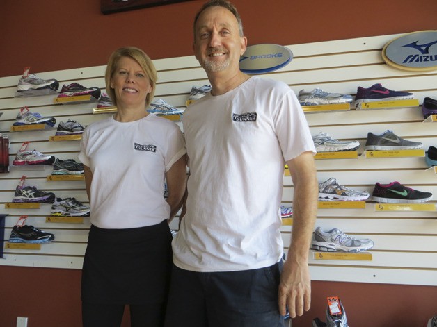 Mark and Elizabeth Steen in front of one of the shoe walls at Plateau Runner