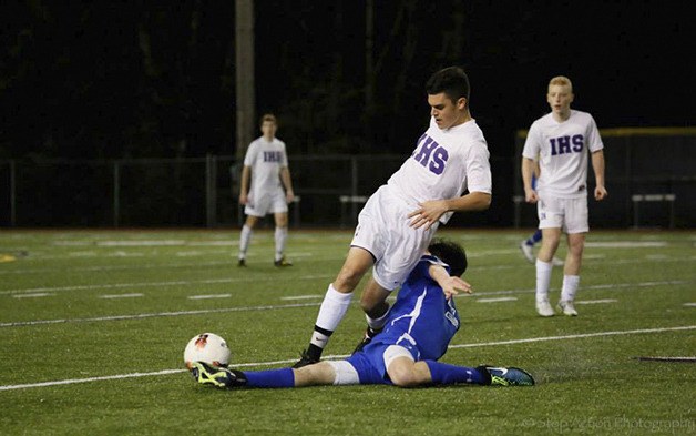 Issaquah Eagles senior Theo Walker gets slide tackled by a Curtis defender in a non-league contest on March 20 at Issaquah High School.
