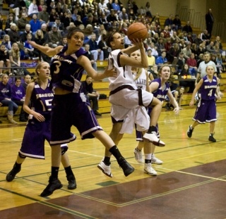 Eastlake's Kelly Montgomery drives to the hoop past Issaquah's Mackenzie Schiltz.