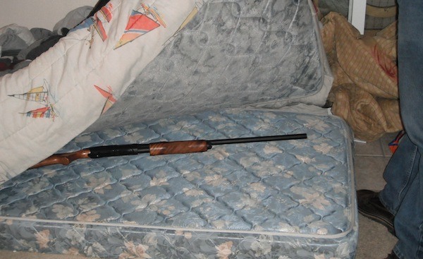 Detectives show off a shotgun stolen from a Sammamish home and recovered in Burien.