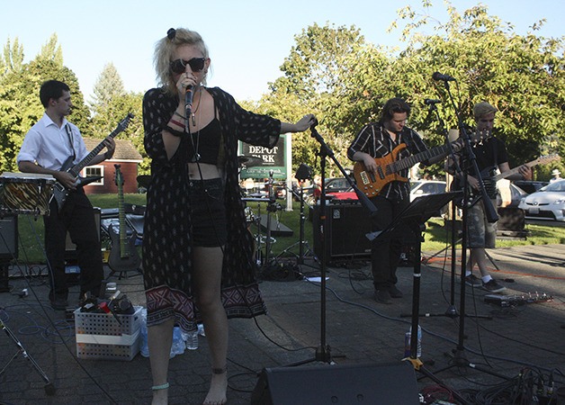 A rock band out of the Kaleidoscope School of Music and its Issaquah Rock School performs at Art Walk. From left