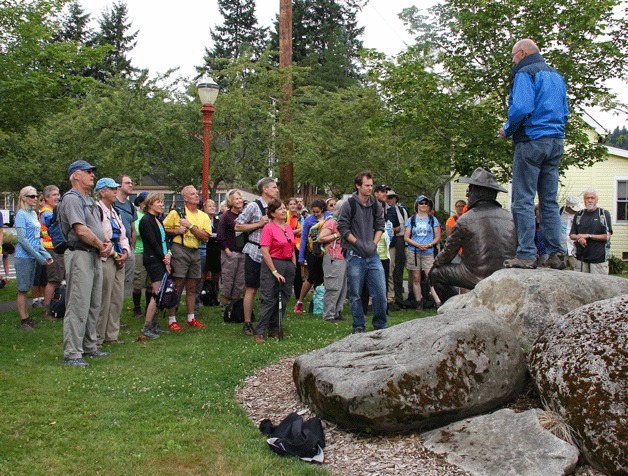 City of Issaquah Mayor Fred Butler welcomes hikers to Issaquah at the Harvey Manning statue.