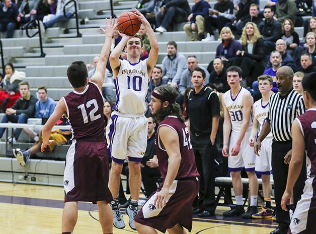 Issaquah sophomore Garrett White hoists a jumper while being defended by Eastlake’s Max Marks on Jan. 22 at Issaquah High School