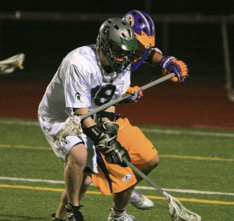 Issaquah's Alexei Burtscher and Skyline's Daniel Christianson fight over a ground ball Tuesday night at Skyline HS. The Eagles defeated the Spartans 11-4.