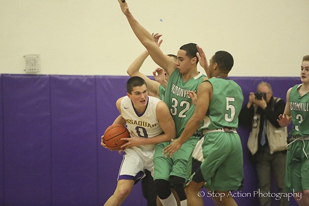 Issaquah Eagles basketball player Tanner Davis is surrounded by a bevy of players in a contest against Woodinville during the 2015-16 season. Davis will be the focal point of the Eagles team as a senior during the 2016-17 season.