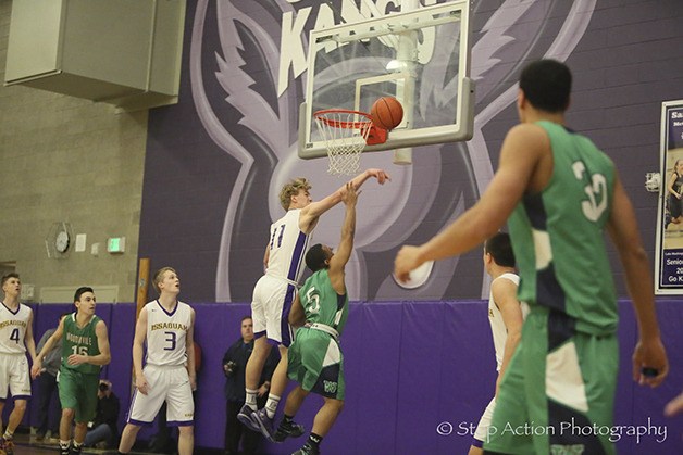Issaquah Eagles basketball player Jack Dellinger blocks a shot against the Woodinville Falcons in the Class 4A KingCo title game on Feb. 18 at Lake Washington High School in Kirkland.
