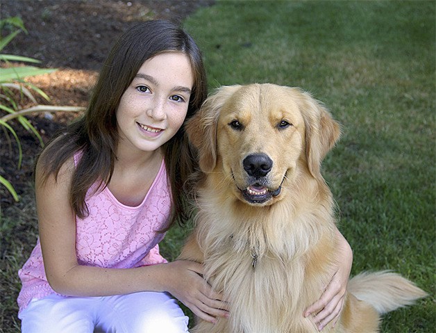 Sixth grader Alison Amirault with her Golden Retriever