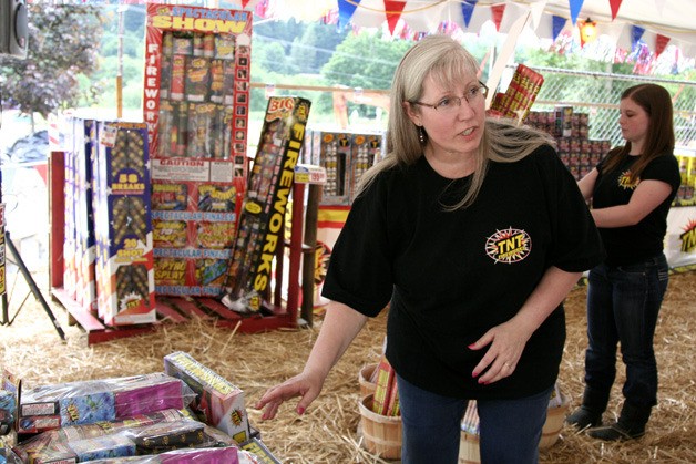 Lynne Davis volunteers at a fireworks sale at Issaquah Christian Church. The project helps send people to Uganda