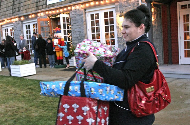 Olena Myroneds carries a load of presents for her children from Eastridge Christian Church's Christmas toy drive. The church gave away about 900 wrapped gifts this year in its first annual drive.