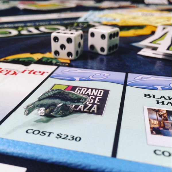 Local items like kokanee salmon replace the familiar die-cast Monopoly pieces in Issaquah-opoly.